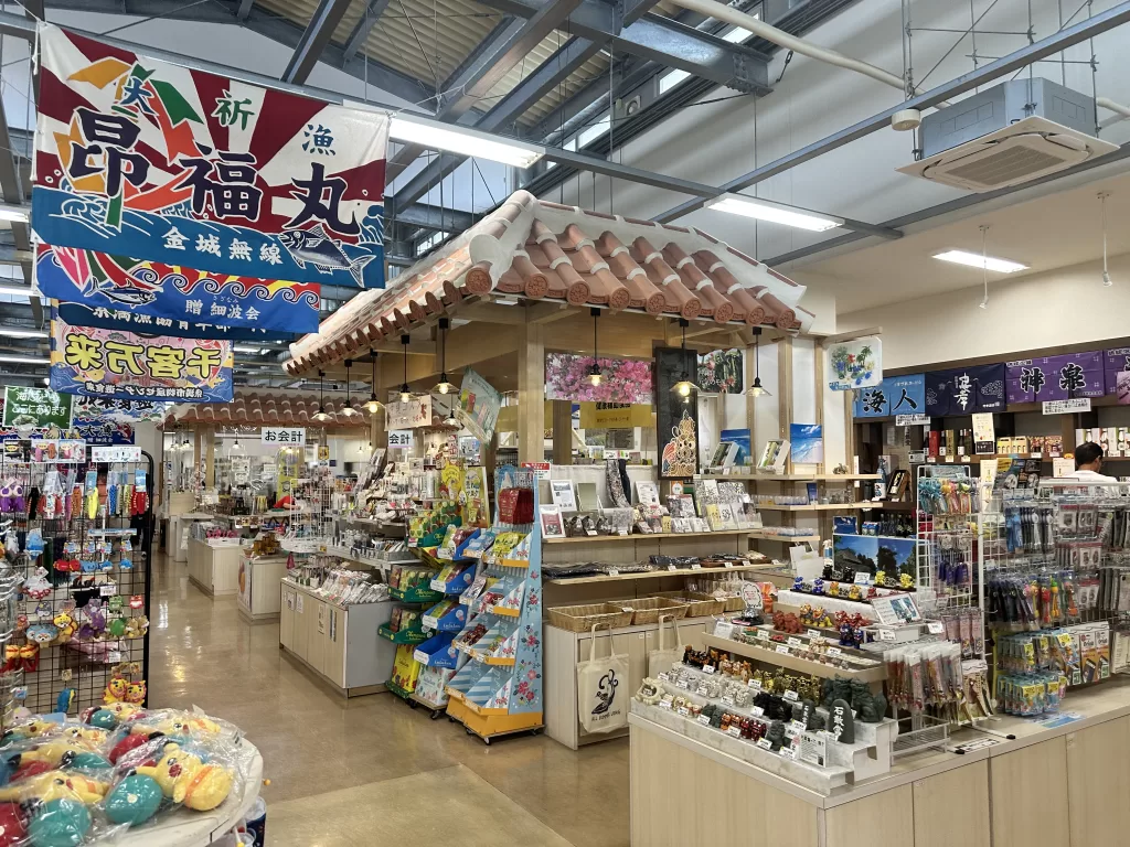 Souvenir aisles under big fishing flags inside Yukura