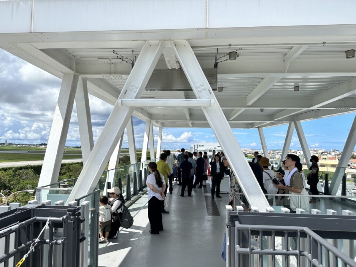 Under the white truss roof of the fourth-floor observation deck