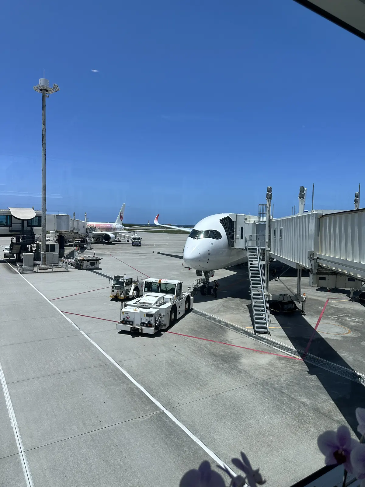 An aircraft parked at a boarding gate at Naha Airport