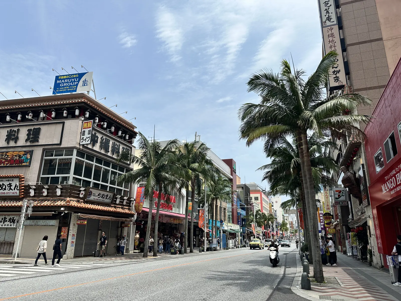 Kokusai-dori in the afternoon, lined with palms and shopfronts