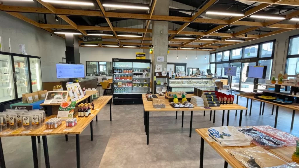 The shop floor at Yambaru Pineapple Hills, with local products and a large touchscreen ordering console behind