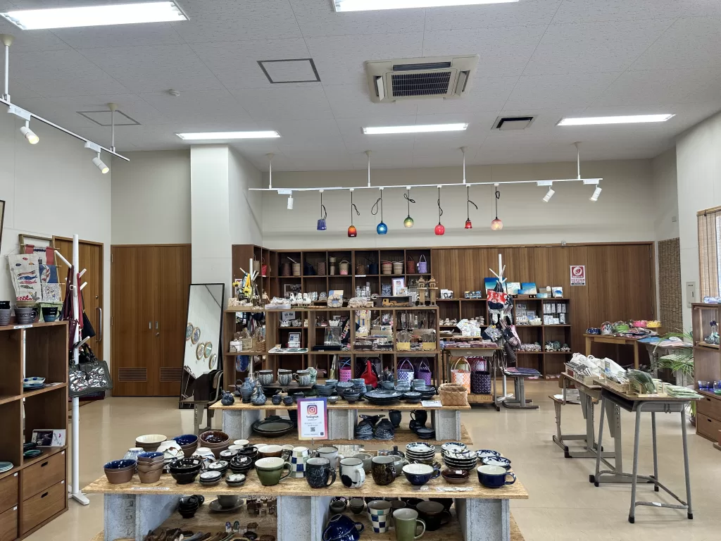 Pottery and handmade crafts on display inside Tigumakan